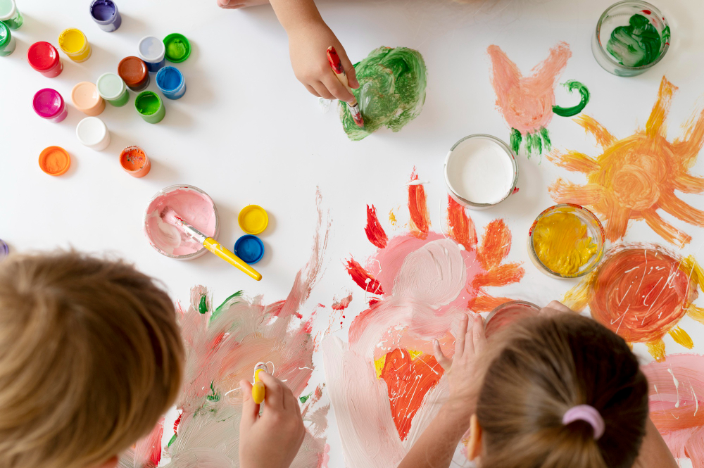 close-up-kids-painting-with-brushes-together.jpg